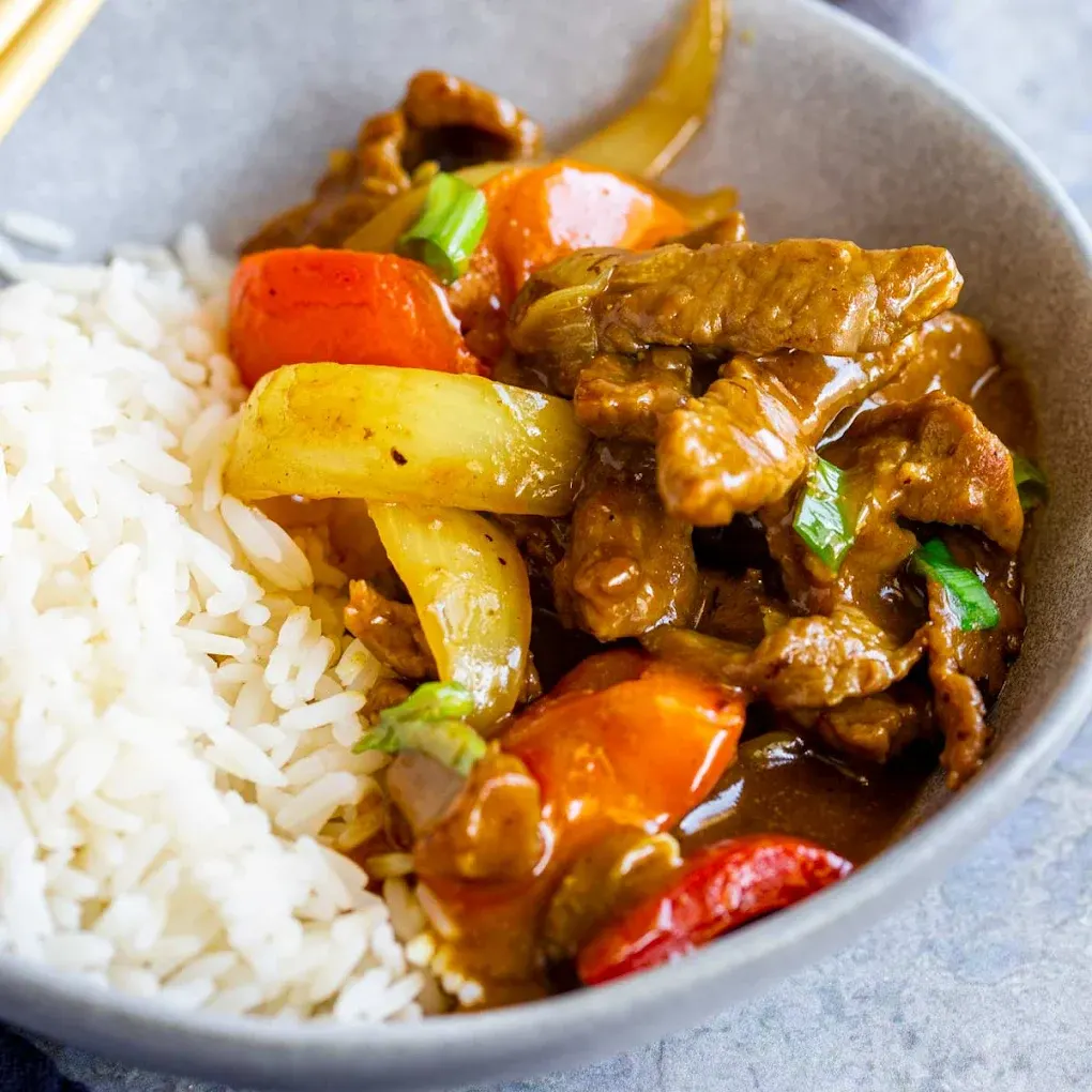 Tender beef with onions over steamed rice at Peking Garden Asian Cuisine